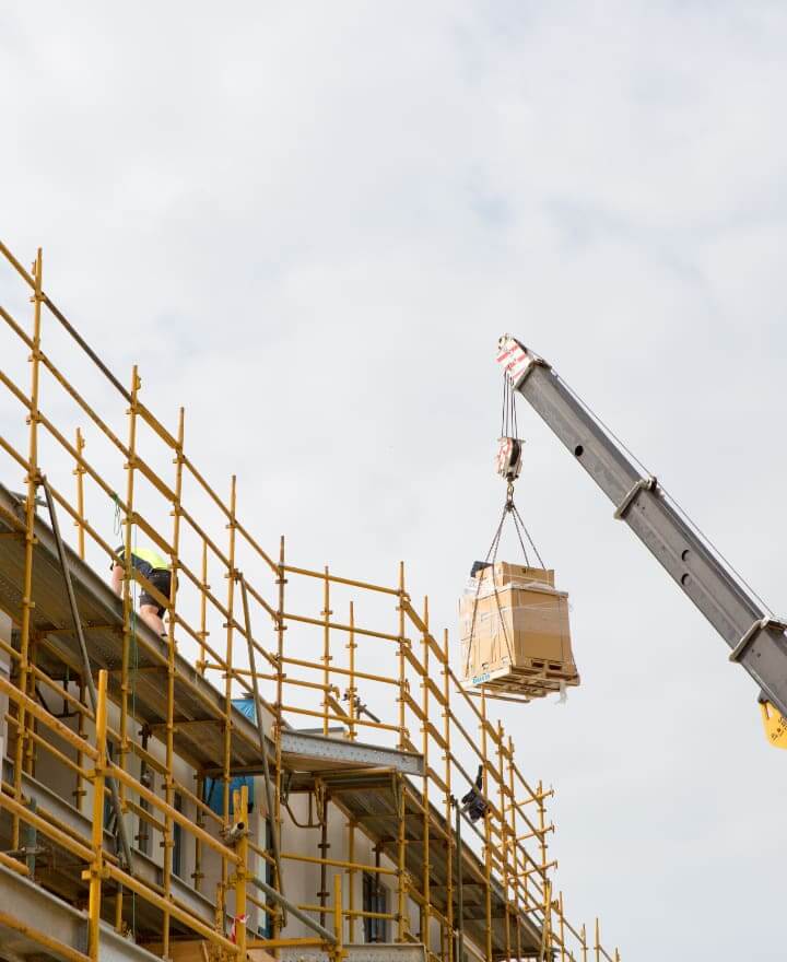 Building site with crane lifting cargo